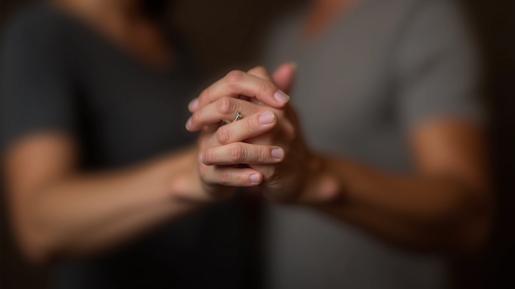 Close-up of hands showing two dancers holding position during a partner dance class with focused concentration